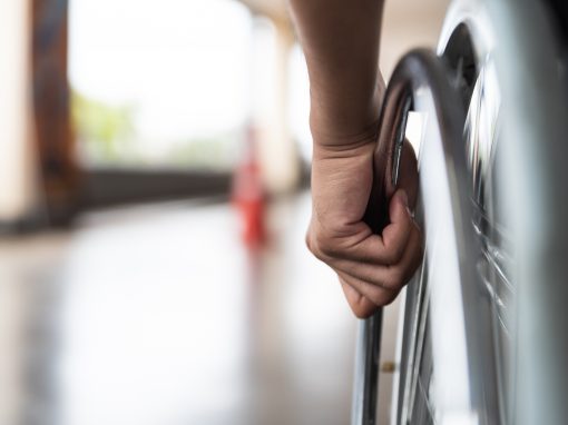 closeup disabled man hand on wheel of wheelchair